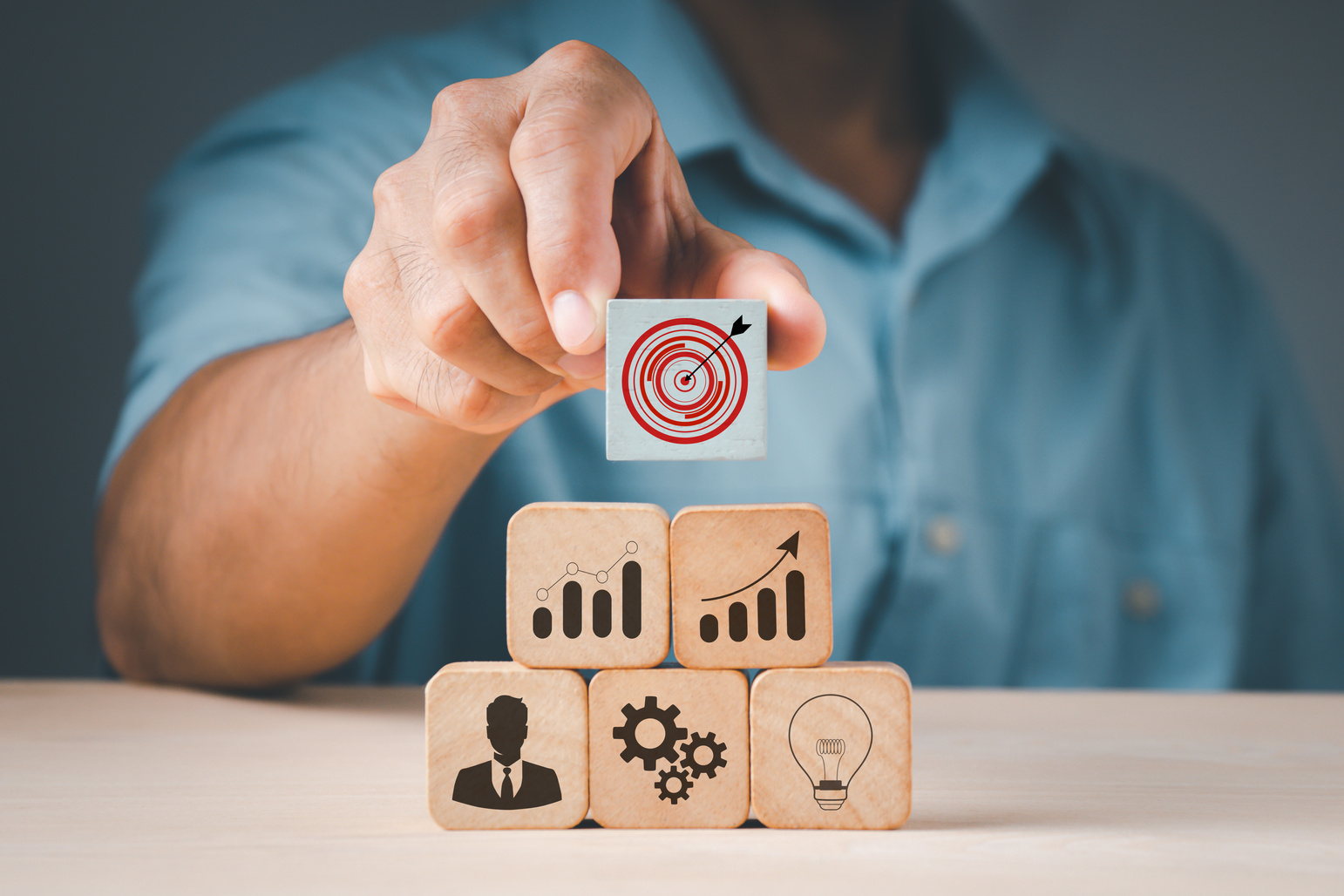 Person Stacking Wooden Blocks
